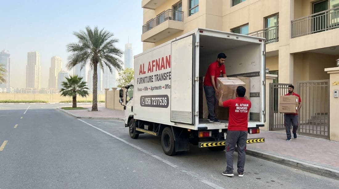 Al Afnan movers and packers in Dubai wrapping a sofa in stretch film before loading the truck